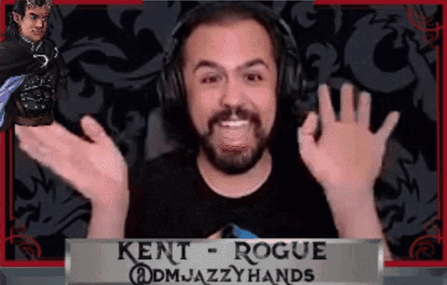 a man wearing headphones and a black shirt with kent rogue on it