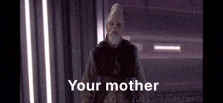 a man with a beard and a hat is standing in a room and says your mother .