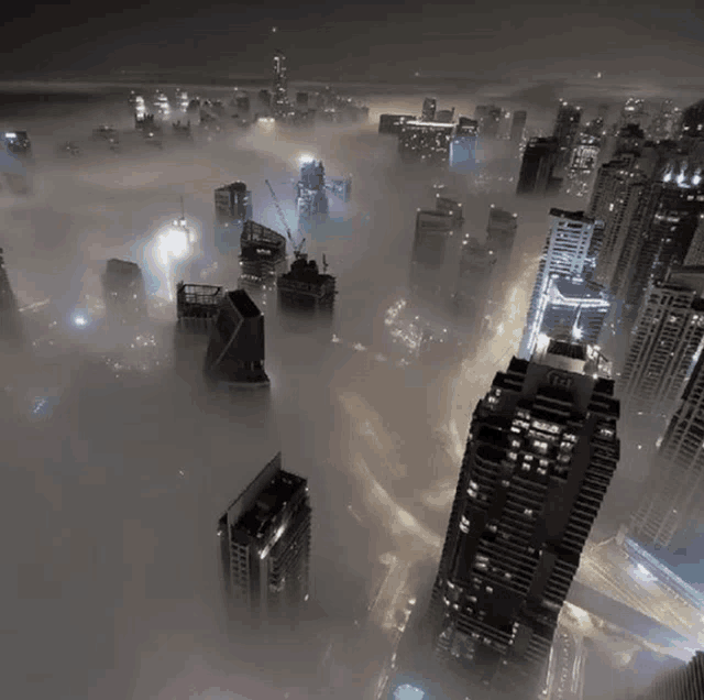 an aerial view of a city at night with a few buildings with the letters eee on them