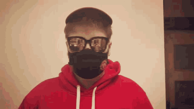 a man wearing a red hoodie and sunglasses with the letter r on his face