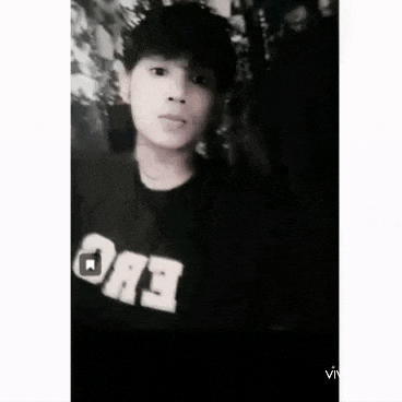 a black and white photo of a young man wearing a black shirt with the word evo on it .