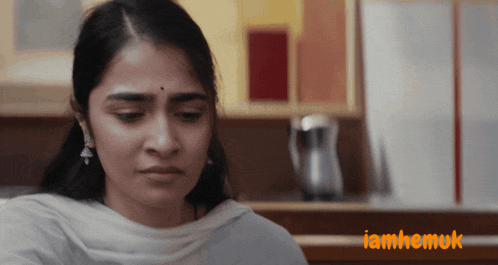 a close up of a woman 's face with the words iamhemuk in orange