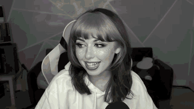 a black and white photo of a woman with freckles