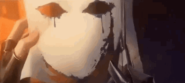 a close up of a person wearing a white mask with blood dripping from it .