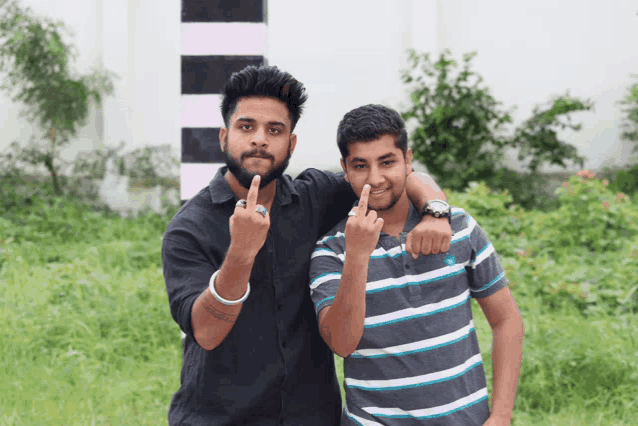 two young men are giving the middle finger