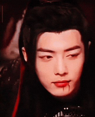 a close up of a person 's face with blood on it