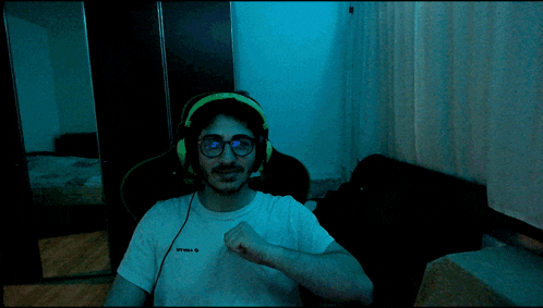 a man wearing headphones and a t-shirt that says " sparta " on it