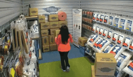 a woman is standing in a store looking at boxes and a sign that says maritime