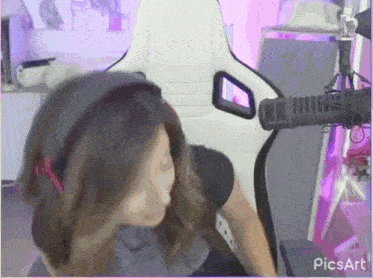 a woman wearing headphones is sitting in front of a microphone in a picsart screen shot