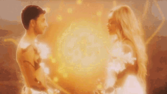 a man and a woman are standing next to each other with fire coming out of them .