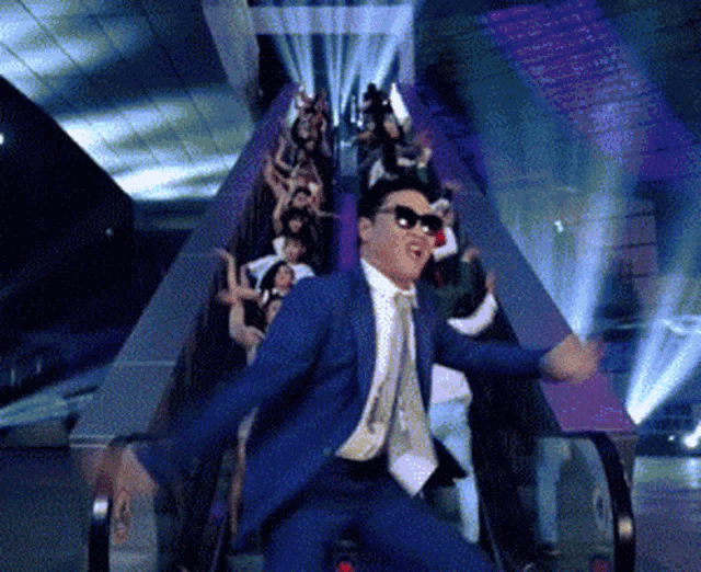 a man in a suit and tie is riding an escalator