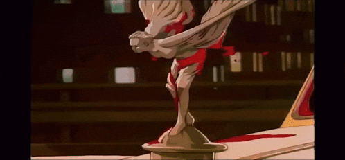 a statue of a woman with wings is sitting on top of a car