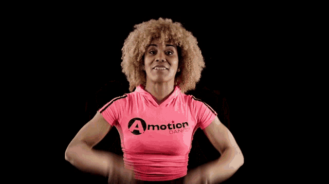 a woman is wearing a pink shirt that says motion
