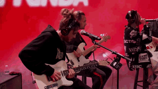 a man playing a guitar in front of a microphone that says ctm video on it