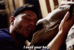 a man is laying on a bed holding a bag and says i need your help