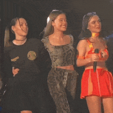 three women are standing next to each other and one of them is wearing a shirt that says cowboy