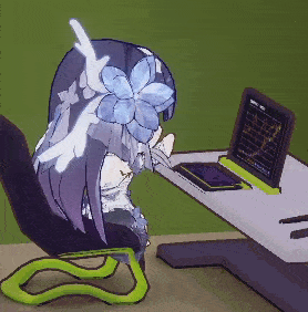 a girl with a flower in her hair is sitting at a desk looking at a laptop