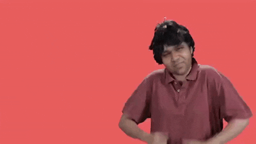 a man in a red shirt is giving two thumbs up in front of a red background .