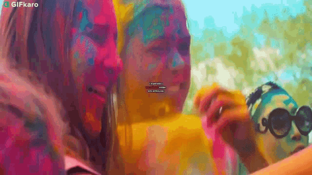 a couple of girls with their faces painted with colored powder