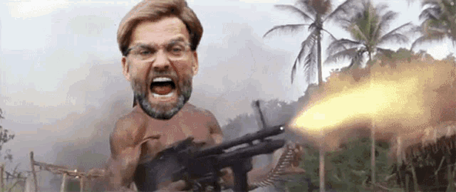 a man without a shirt is holding a gun in front of a palm tree