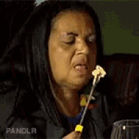 a woman is eating a mushroom with her mouth open .