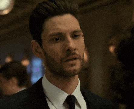 a man in a suit and tie is looking at something