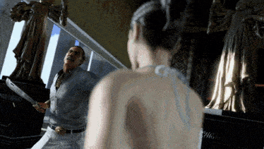 a man is holding a knife in front of a woman in a white dress