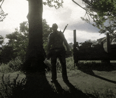 a man in a cowboy hat is standing next to a tree in a field