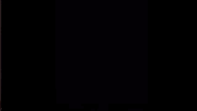 a close up of a person 's face with a dark background
