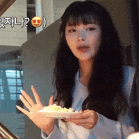a woman is holding a plate of food in her hand with a smiley face on it