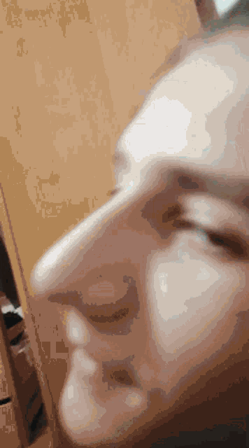 a close up of a person 's nose with their eyes closed .