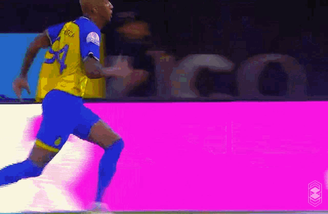 a soccer player in a yellow and blue jersey with the number 31 on it