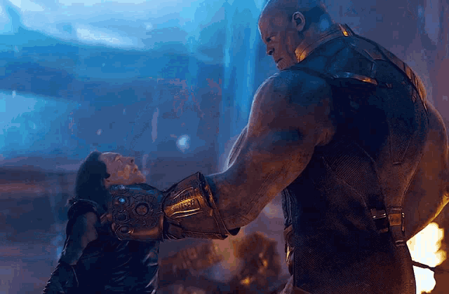 a man wearing a glove that says infinity gauntlet