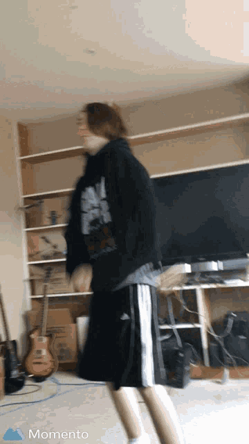a blurry picture of a person in a living room with the word momento in the corner