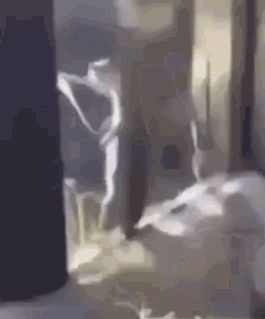 a painting of a person standing in a room with a light coming out of a window .