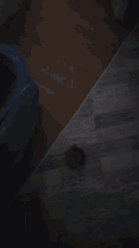 a dark corner of a room with a blue chair