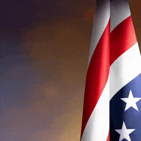 two american flags are displayed in front of a dark background