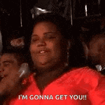 a woman is wearing a red jacket and saying `` i 'm gonna get you ! ''