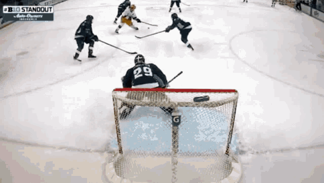a hockey game is being played and the goalie is wearing the number 22