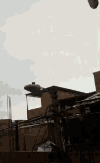 a street light is hanging from a pole in the sky