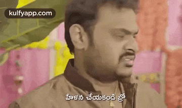 a man with a beard is making a funny face and talking in telugu .