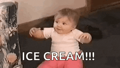 a baby is sitting on a couch with a box of ice cream in the background .