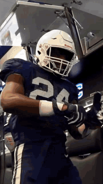 a football player wearing a white helmet with the number 24 on it