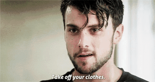 a man with a beard is talking to someone and says `` take off your clothes . ''