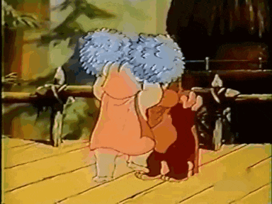 a girl in a pink dress is hugging a cat