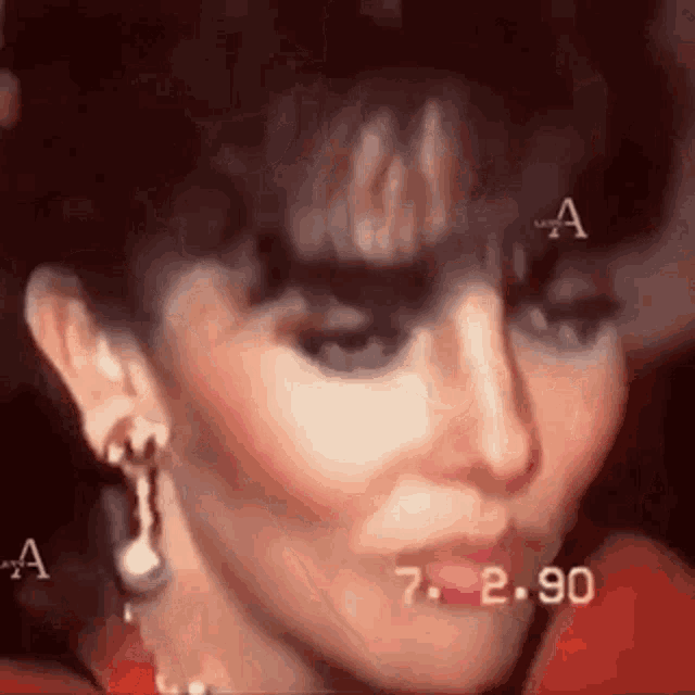a close up of a woman 's face with a red dress on .