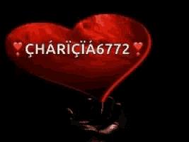 a hand is holding a red heart with the words " charicia6772 " on it