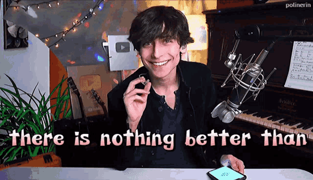 a young man sitting in front of a microphone with the words " there is nothing better than " behind him