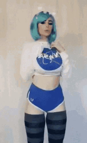 a woman wearing a nasa sweater and blue shorts is dancing .