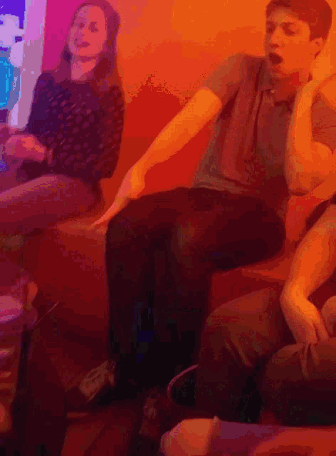a group of people are sitting on a couch and one of them is wearing a shirt that says nike